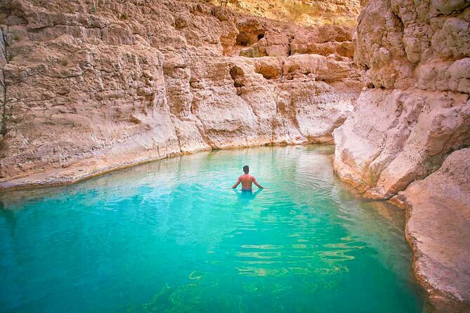 Full Day Wadi Shab And Bimah Sinkhole with Pick Up Included - Walking through the canyon to the natural pools