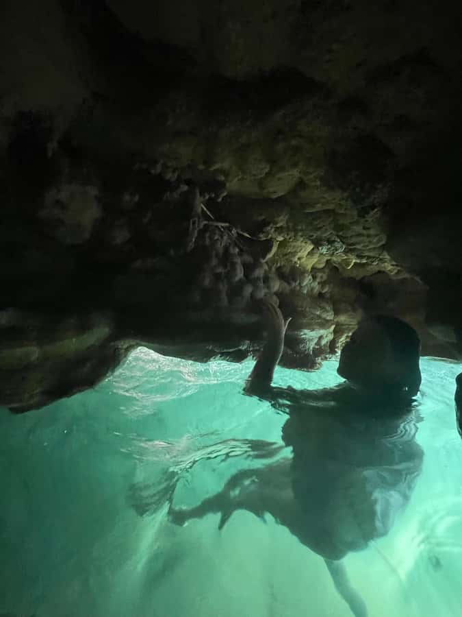 Muscat: Wadi Shab, Romantic Cave and Sinkhole Full-day Trip - Crossing the river into Wadi Shab