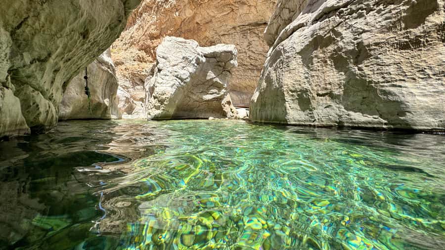 Muscat: Wahiba Desert and Wadi Bani Khalid Guided Group Tour - Wadi Bani Khalid: water, palms, and canyon paths